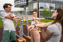 Group Of Friends Couple Woman And Man Stretching Before Or After Training In The Open Gym Outdoor In Day In The City Real People Healthy Lifestyle Concept Leisure Amateurs Exercise