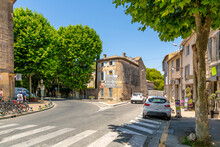 Sign Posts Pointing Towards Avignon, The Alpilles And The Tourism Office At An Intersection In The Medieval Center Of Saint-Remy-de-Provence In Provence, France.