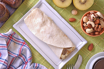 Wall Mural - Creamy chicken with mushroom burrito on white plate