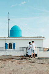 Wall Mural - happy couple travelers in front of Church of the Prophet Elias