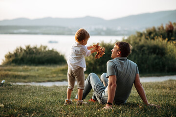 dad and son play on the seashore, vacation with children. summer adventure, fun trip with kids. fath