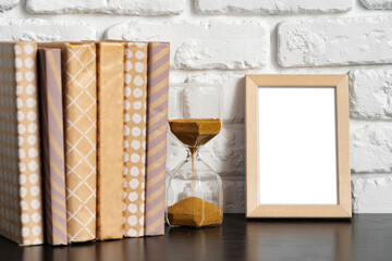 Poster - Books with picture frame on wooden table