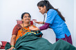 © WESTOCK - Nurse checking health of middle aged woman at nursing home using stethoscope - concept of routine checkups, caretaker and consultation