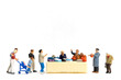 © Sirichai Puangsuwan - Miniature people Shoppers with discount tray for shopping discounted items on white background