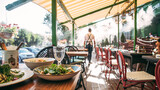 Fototapeta Na sufit - Outdoors summer terrace cafe with served table and waiter