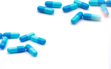 Wall Mural - Blue antibiotic capsule pills on white background. Prescription drugs. Antibiotic drug resistance. Antimicrobial capsule pills. Pharmaceutical industry. Healthcare and medicine. Pharmacy product.