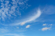 Beautiful blue summer sky and white cirrocumulus clouds background. Cloudscape background. Blue sky and fluffy white clouds on a sunny day. Nice weather in summer. Beauty in nature. Summer sunny sky.