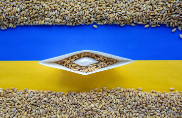 Wall Mural - grain wheat and spikelets on a blue background. Ukrainian grain and problems of sea blockade of ports.	
