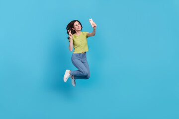 Canvas Print - Full size photo of cool young brunette lady jump do selfie wear t-shirt jeans shoes isolated on blue background