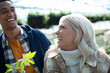 © Caia Image - Happy couple laughing at plant nursery