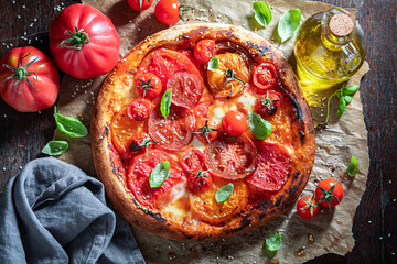 Wall Mural - Tasty and healthy pizza Margherita with various tomatoes and mozzarella.