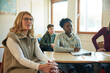 © Johnér - Group of students and teacher sitting in class
