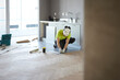 © Johnér - Worker installing floor in kitchen