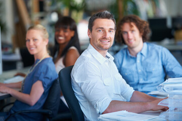 Wall Mural - We put hardwork into everything we do. Cropped shot of four businesspeople sitting in the office.