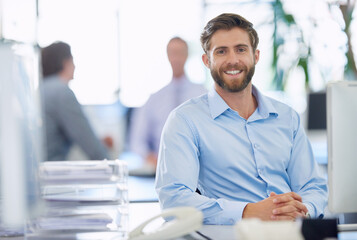 Poster - Hes a real go-getter. Portrait of a handsome young businessman sitting at his office desk.