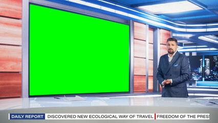 Wall Mural - Talk Show TV Program: Handsome White Male Presenter Standing in Newsroom Studio, Uses Big Green Chroma Key Screen. News Achor, Host Talks About News, Weather. Mock-up Cable Channel Concept.