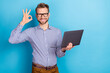 © deagreez - Photo of attractive businessman showing okay symbol working in netbook new project isolated on blue color background