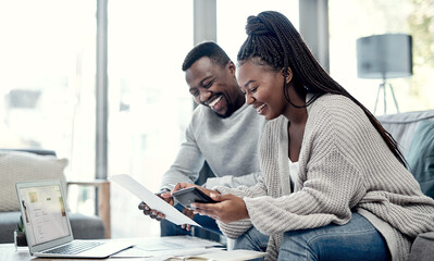Poster - Were on our way to a loan free life. Shot of a young couple going through paperwork at home.