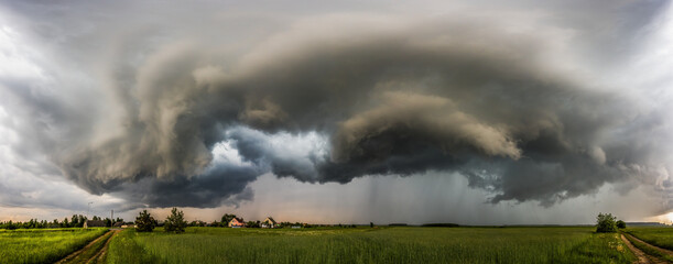 Storm clouds over field, extreme weather, dangerous storm