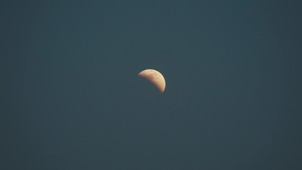 Wall Mural - real time lunar eclipse viewed in the sky with the moon partially covered as shadow of earth creeps 