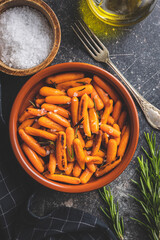 Sticker - Roasted baby carrots with salt and rosemary in bowl.