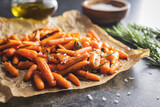 Fototapeta Kawa jest smaczna - Roasted baby carrots with salt and rosemary on baking paper.