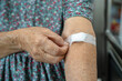 © amazing studio - Asian senior or elderly old lady woman patient show cotton wool stop bleeding, after blood drawing testing for annually physical health check up to check cholesterol, blood pressure, and sugar level.
