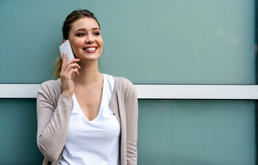 Wall Mural - Beautiful business woman using mobile phone outdoors. People communication technology concept.