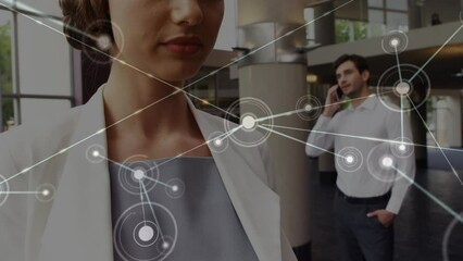 Poster - Network of connections against caucasian businesswoman smiling while using smartphone