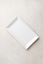 Rectangular White Plate On A Light Stone Background, The Concept Of Food, Restaurant