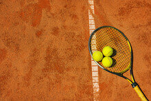  A Yellow Tennis Ball And Tennis Racket Lies On The Clay Court.