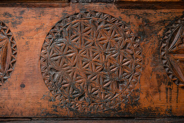 Close-up of a carved decoration on wood
