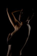 © Nikola Spasenoski - Portrait of a girl with short hair against dark background. Side lit contour slhouette of a female body..
