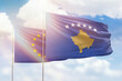 Sunny blue sky and flags of kosovo and european union