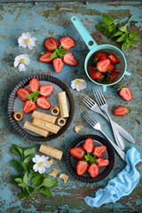 Wall Mural - Homemade cakes and fresh red strawberries on an old rustic background. Healthy breakfast with berries. view from above