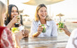 Young attractive women drink mojito on the beach while listening chill music - travel, fun, vacation concept