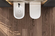 Top view of bathroom with toilet and bidet, beautiful parquet in minimalist bathroom. 3d Rendering