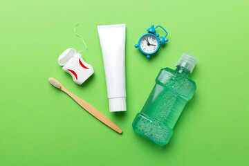 Mouthwash and other oral hygiene products on colored table top view with copy space. Flat lay. Dental hygiene. Oral care products and space for text on light background. concept