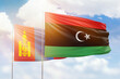 Sunny blue sky and flags of libya and mongolia