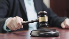 Slow Motion Judge's Hand With Wooden Gavel Hitting Gavel In Courtroom