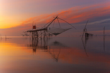  The scenery of sunrise and sunset view with giant fishing traps in Southern of Thailand.