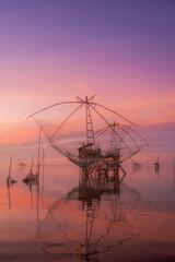  The scenery of sunrise and sunset view with giant fishing traps in Southern of Thailand.