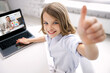 © Syda Productions - education, online school and technology concept - smiling student girl with laptop computer and teacher on screen showing thumbs up at home