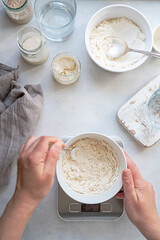 Wall Mural - Homemade breadmaking with sourdough using wild yeast, busy lifestyle scene of baking at home, top view. Sustainable living