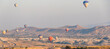 banner with many hot air balloons in the sky over a valley in Cappadocia, Nevsehir, Turkey in a beautiful summer day. sofy focus