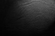 © Gudman - Black leather texture. Abstract background of dark leather with small roughness and scuffs