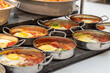 Typical Israeli breakfast buffet at any hotel. Close up of single servings of shakshuka a traditional Israeli egg dish with tomatoes and seasonings.
