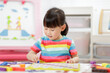 © M-image - young girl play number blocks for homeschooling