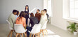 © Studio Romantic - Diverse business team meeting in modern white office. Group of people listening to serious young woman who's standing in front of them, explaining some rules and talking about importance of management