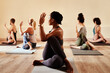 © C Malambo/peopleimages.com - On the mat youll find out what truly matters. Shot of a group of young men and women practicing yoga in a fitness class.